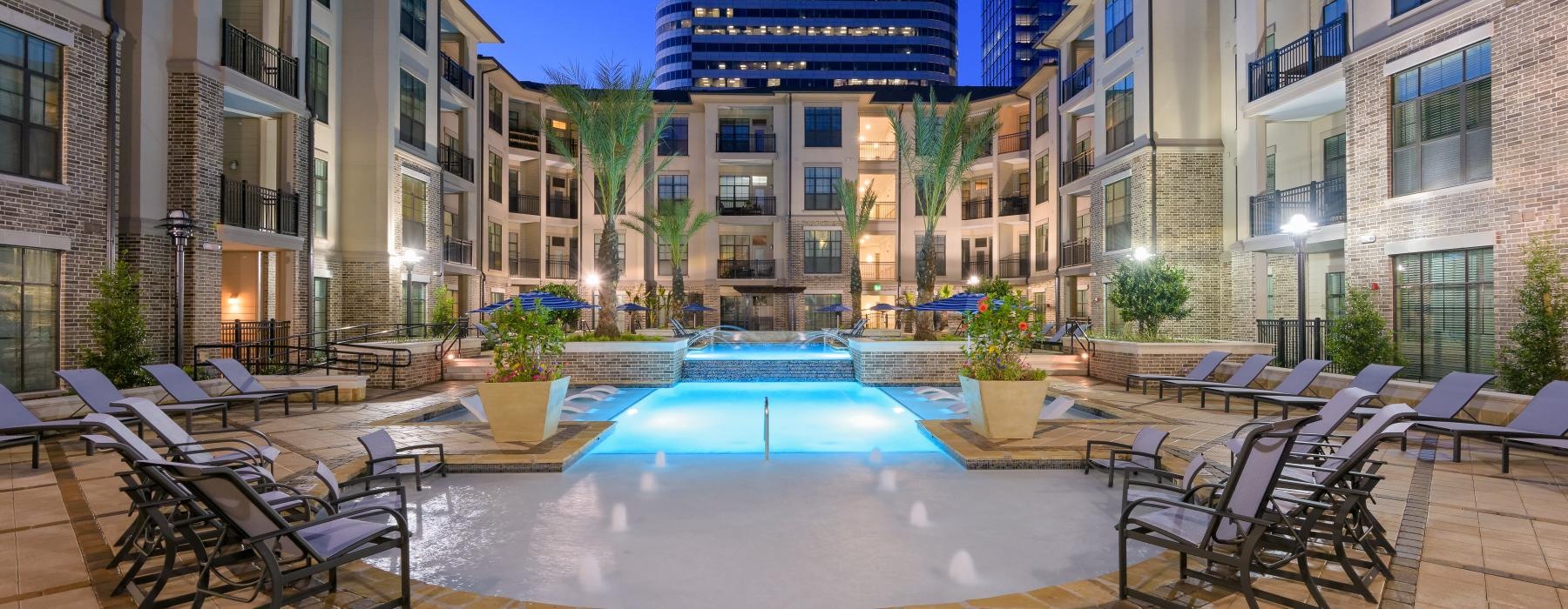 a pool in a courtyard between buildings