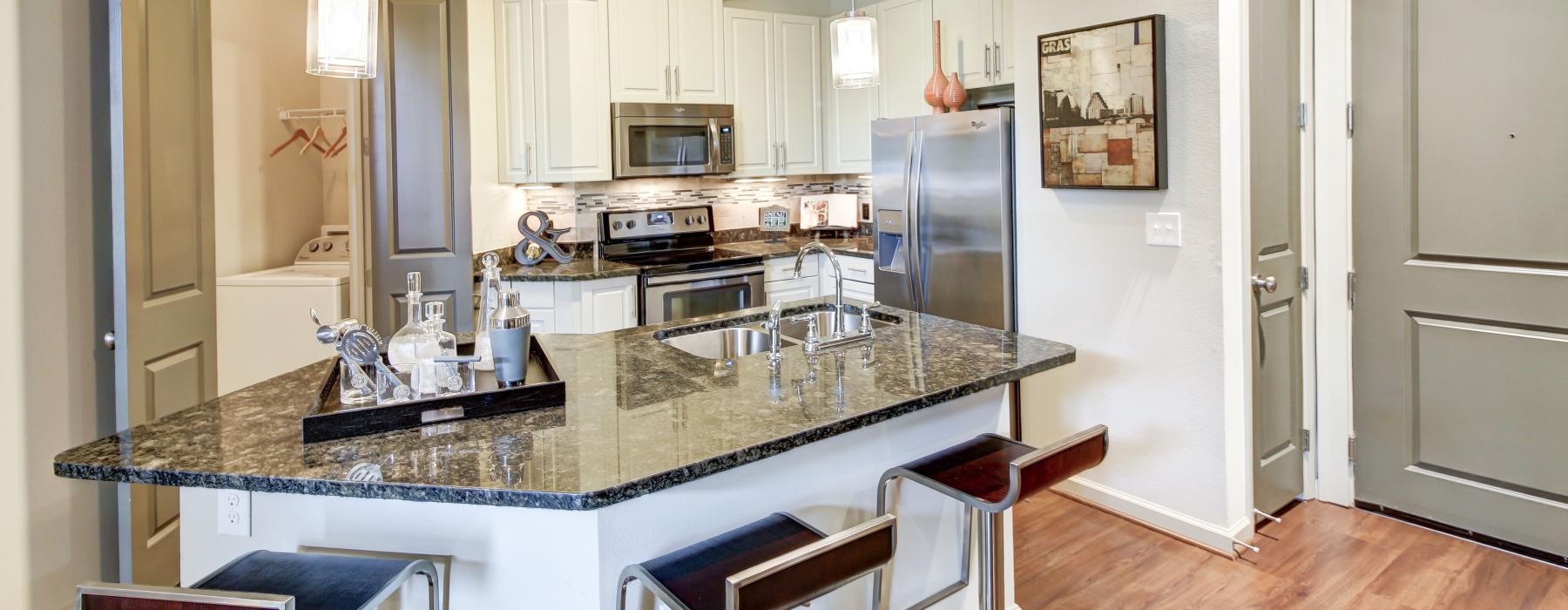 a kitchen with a marble island